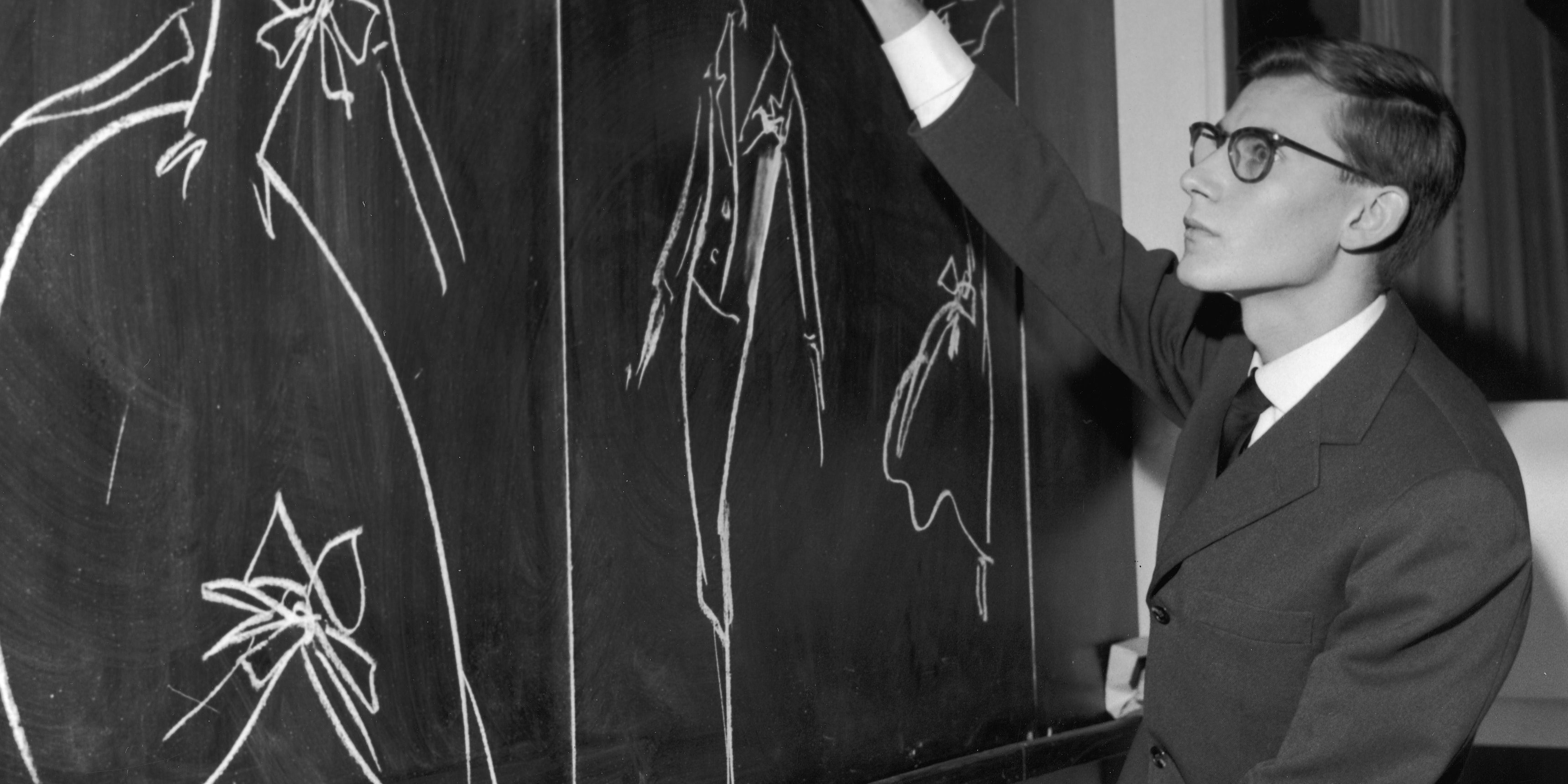 Yves Saint-Laurent Sketching On Chalkboard