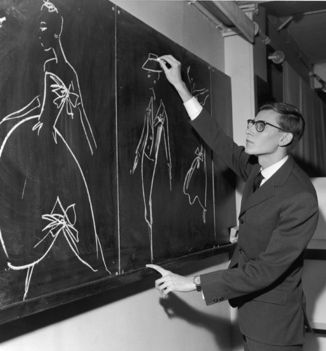 Yves Saint-Laurent Sketching On Chalkboard